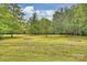 Expansive lawn featuring large shade trees is ideal for recreational activities and enjoying the natural surroundings at 321 York Southern Rd, Fort Mill, SC 29715