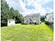 Spacious backyard featuring a well-maintained lawn, shed, and patio area perfect for outdoor entertaining at 4048 Cascade Dr, Gastonia, NC 28056