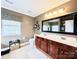 Bathroom featuring a double sink vanity, decorative mirror, toilet, and window at 4048 Cascade Dr, Gastonia, NC 28056