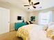 Bright bedroom with a ceiling fan, bed, dresser, tv and a black armchair at 4048 Cascade Dr, Gastonia, NC 28056