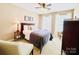 Cozy bedroom with carpet flooring, a bed, side table and armchair by two bright windows at 4048 Cascade Dr, Gastonia, NC 28056
