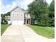 Traditional two-story home with a well-manicured lawn, two-car garage, and inviting red front door at 4048 Cascade Dr, Gastonia, NC 28056