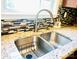 Close-up of a stainless steel kitchen sink with a modern faucet and decorative tile backsplash at 4048 Cascade Dr, Gastonia, NC 28056