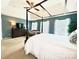 Spacious main bedroom with a four-poster bed, sitting area, and a large dresser with tv at 4048 Cascade Dr, Gastonia, NC 28056