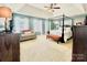 Spacious main bedroom boasts a four-poster bed, sitting area and abundant natural light at 4048 Cascade Dr, Gastonia, NC 28056