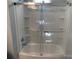 Bathtub and shower with a sliding glass door and shelving at 419 W 8Th St, Newton, NC 28658