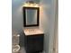 Powder room features a single sink vanity, framed mirror and toilet at 419 W 8Th St, Newton, NC 28658