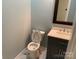 Powder room features a single sink vanity, framed mirror and toilet at 419 W 8Th St, Newton, NC 28658
