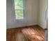 Bright bedroom with hardwood floors, a window, and fresh paint at 419 W 8Th St, Newton, NC 28658