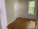 Cozy bedroom featuring hardwood floors, a window, and a closet at 419 W 8Th St, Newton, NC 28658