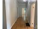 Long hallway with hardwood floors and neutral colored walls at 419 W 8Th St, Newton, NC 28658