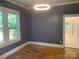 Living room with hardwood floors, gray walls, and modern light fixture at 419 W 8Th St, Newton, NC 28658