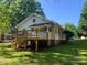 Picture of the house's rear elevated deck and well maintained lawn and gardens on a sunny day at 419 W 8Th St, Newton, NC 28658