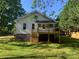 Picture of the house's rear elevated deck and well maintained lawn on a sunny day at 419 W 8Th St, Newton, NC 28658