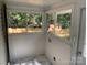 Sunroom featuring marble tile flooring, white walls and multiple windows at 419 W 8Th St, Newton, NC 28658