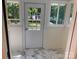 Sunroom with white marble tile flooring and windows overlooking the backyard at 419 W 8Th St, Newton, NC 28658