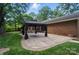 An exterior shot of the backyard patio, gazebo, and mature trees offering a serene and secluded outdoor space at 4323 Crow Rd, Monroe, NC 28112