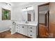 Bathroom featuring a white vanity with a quartz countertop, and a window over the toilet at 4323 Crow Rd, Monroe, NC 28112