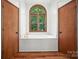 Bathroom with bathtub, hardwood floors, and arched window that provides natural light at 4323 Crow Rd, Monroe, NC 28112