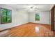 Bright bedroom with hardwood floors, ceiling fan, and natural light from large windows at 4323 Crow Rd, Monroe, NC 28112