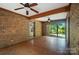 Brick enclosed porch with exposed beams and access to the backyard through sliding glass doors at 4323 Crow Rd, Monroe, NC 28112