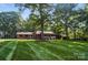 Charming single-story home with a well-manicured lawn and mature trees providing ample shade at 4323 Crow Rd, Monroe, NC 28112