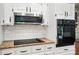 Close up on modern kitchen appliances including microwave, oven, cooktop, and granite countertops at 4323 Crow Rd, Monroe, NC 28112