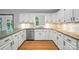 Bright kitchen with white cabinets, granite countertops, stainless steel dishwasher, and wooden floors at 4323 Crow Rd, Monroe, NC 28112