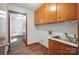 Functional laundry room with overhead cabinets, a sink, and direct access to a spacious hallway at 4323 Crow Rd, Monroe, NC 28112