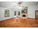 Open living room featuring hardwood floors, stone fireplace, and natural light at 4323 Crow Rd, Monroe, NC 28112