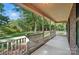 View of a covered porch with white railings, offering a view of a spacious lawn at 4323 Crow Rd, Monroe, NC 28112