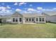 The back exterior of this home features a well-manicured lawn and a cozy patio area at 440 Shallowford Dr, Rock Hill, SC 29732