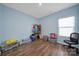 Bedroom with light blue walls, hardwood floors and storage rack at 440 Shallowford Dr, Rock Hill, SC 29732