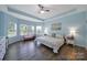 The bedroom features a patterned bedspread, three large windows, and tray ceiling at 440 Shallowford Dr, Rock Hill, SC 29732