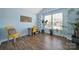 Bright bedroom with hardwood floors, blue walls, a desk and a yellow chair and beautiful plants at 440 Shallowford Dr, Rock Hill, SC 29732