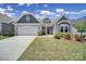 Charming one-story home with a well-manicured lawn, inviting entrance, and attached two car garage at 440 Shallowford Dr, Rock Hill, SC 29732