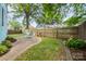 Spacious backyard featuring a patio area, green lawn, flower bed and wood fence at 501 Mercury St, Charlotte, NC 28205