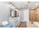 Bright bathroom featuring double vanities with marble countertops, and a tiled walk-in shower at 501 Mercury St, Charlotte, NC 28205