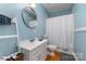 Bathroom featuring a white vanity, toilet and a shower with a white curtain at 501 Mercury St, Charlotte, NC 28205