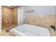 Bright bathroom featuring tiled walls and a modern soaking tub with a separate shower at 501 Mercury St, Charlotte, NC 28205