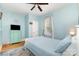 Comfortable bedroom with blue walls, wood floors, dresser, and a window with natural light at 501 Mercury St, Charlotte, NC 28205