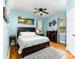 Comfortable bedroom with warm hardwood floors, ceiling fan, and natural light at 501 Mercury St, Charlotte, NC 28205