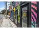 The exterior shows a unique and colorful commercial property on a city street with striking painted murals at 501 Mercury St, Charlotte, NC 28205
