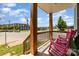 Covered front porch with wood railings and comfortable rocking chairs overlooking a street at 501 Mercury St, Charlotte, NC 28205