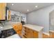 Spacious kitchen featuring custom cabinetry, counter seating and modern appliances at 501 Mercury St, Charlotte, NC 28205