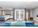Bright living room featuring a comfortable blue couch and an adjoining bedroom at 501 Mercury St, Charlotte, NC 28205