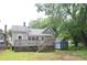 Exterior view of the home featuring a spacious backyard deck with yard and storage shed at 510 5Th St, Spencer, NC 28159