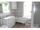 Bright bathroom featuring a vintage clawfoot tub and modern vanity for a blend of styles at 510 5Th St, Spencer, NC 28159
