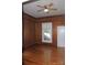Bedroom featuring wood paneled walls, hardwood floors, a ceiling fan and natural light at 510 5Th St, Spencer, NC 28159