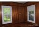 Bright bedroom with wood paneling and natural light from two windows creating a warm ambiance at 510 5Th St, Spencer, NC 28159